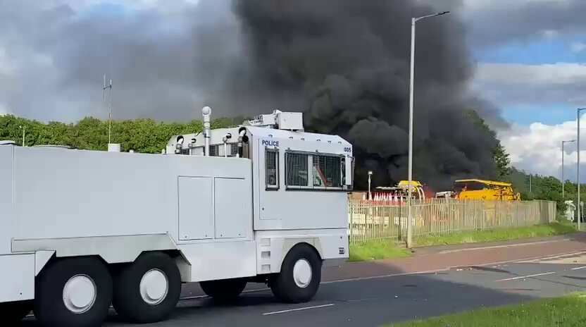 BREAKING: Riot police deployed this evening as 200 masked youths attempt to march toward migrant hotel in Newtownabbey