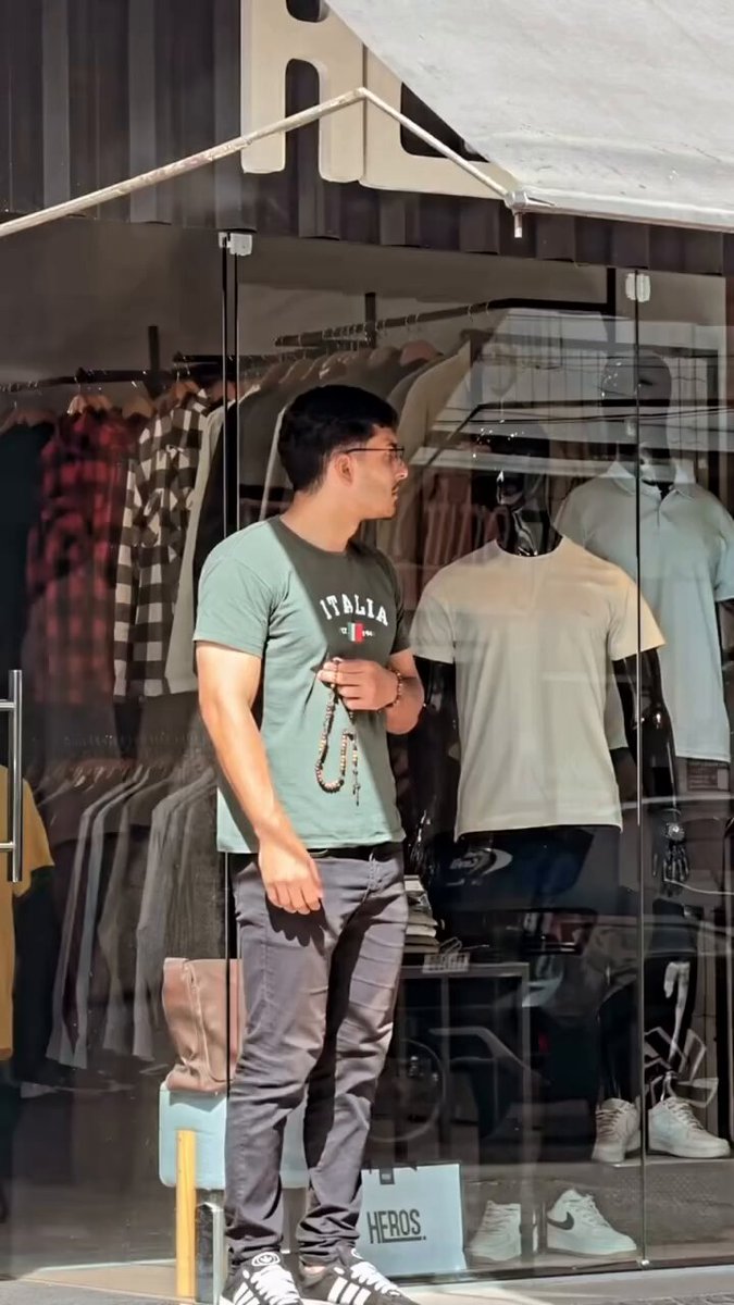 A young man reciting the Rosary in a public place.