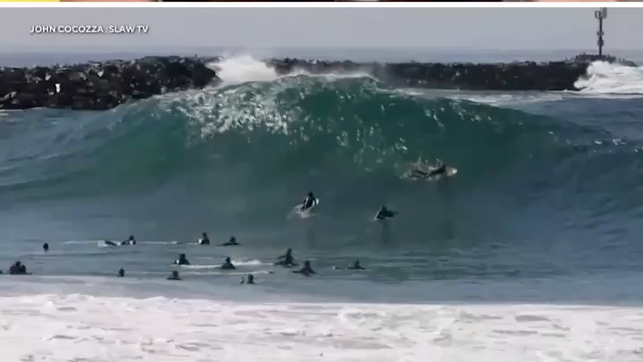 Historic waves reaching up to 20 feet along Southern California’s coast have triggered roughly 100 rescues in recent days, prompting the National Weather Service to urge beachgoers to stay out of the water.