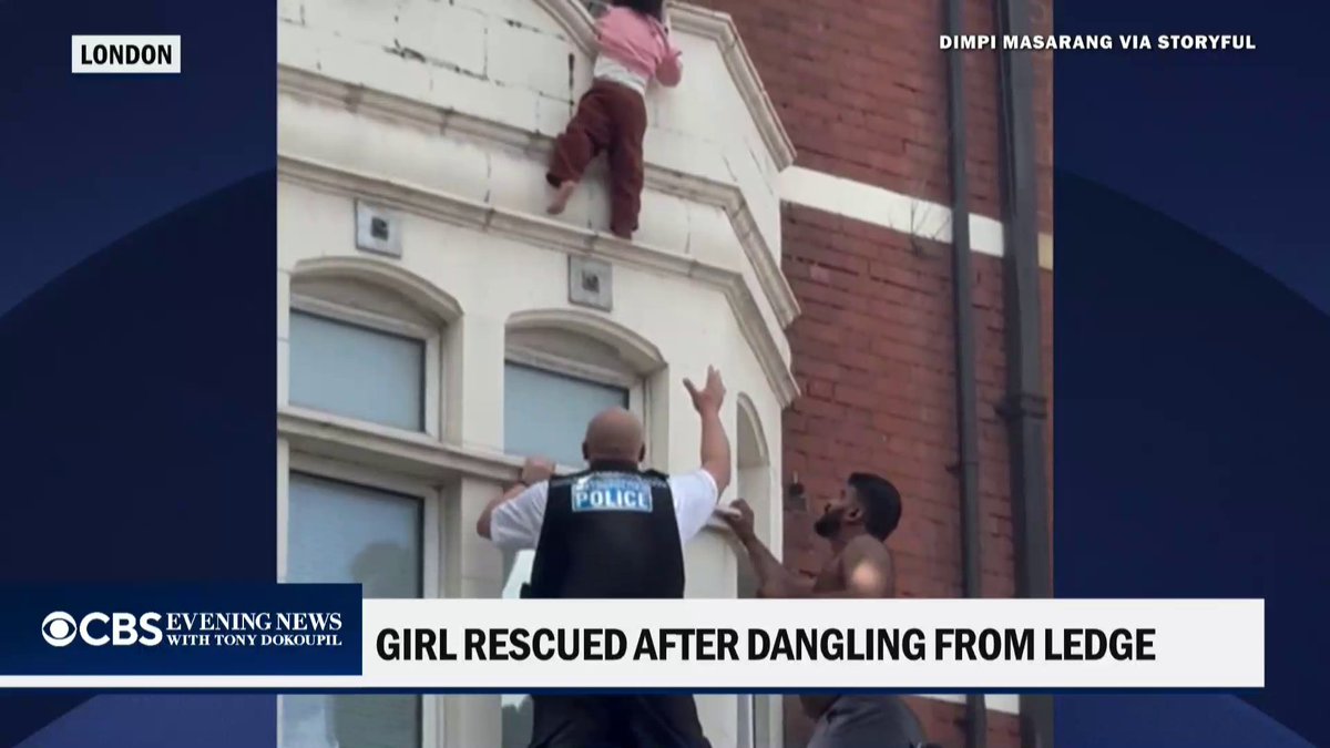 A young girl seen dangling from a window ledge in London was caught by an amateur cricket player and a police officer.