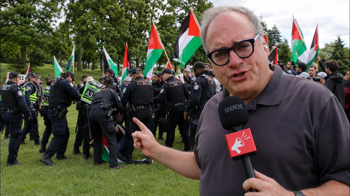 1,000 police deployed so Jewish families can safely march at Walk with Israel I spent Sunday on Bathurst Street in Toronto for the annual Walk with Israel — and the scene tells you everything you need to know about the state of this country right now. Bathurst Street is the heart of Toronto's Jewish community. Synagogues, schools, restaurants, shops. Jewish life has been here for a century. It has also, in recent years, become the site of near-weekly antisemitic vandalism, shootings, and arson. Police have largely looked the other way. I was personally arrested here last year for doing journalism by Officer MacDuff, who was back on duty again today. I'm currently suing him and the Toronto Police Force for false arrest. For the third year running, Mayor Olivia Chow, Premier Doug Ford, and Prime Minister Mark Carney all skipped the Walk with Israel. They've done the demographic math. Meanwhile, an estimated 1,000 to 2,000 police were deployed so that Jewish families — kids, grandparents, strollers, dogs — could walk down their own street without being attacked. No other community in this city requires that. A small counter-protest did show up, flying Ayatollah Khamenei flags alongside Palestinian ones. This is not an organic movement. Antisemitic signs were being mass-produced. The organizers are among the estimated 700 Iranian-regime-linked individuals the federal government knows are operating in Canada — and does nothing about. Today, for once, the police actually pushed them back. Mounted officers formed a barrier and moved the protesters away from the march route. It was a very different approach from the concierge service these same activists have received for the past three years. Along the route I spoke with marchers, Rebel fans, and community members, including a local resident who told me he knows the weekly protesters by name and address, and still can't get anyone in authority to act. Ontario Solicitor General Michael Kerzner, who is responsible for policing, has been aware of foreign funding behind these terror-linked organizers since 2023. Nearly three years later: nothing. Our Rebel News billboard truck was on the street all day, rotating messages including our petition at If you're not a citizen and you support terrorism, you should be gone. Simple as that. It was a good day. But it shouldn't take a thousand police just to go for a walk. REPORT by Ezra Levant 🍁🚛: