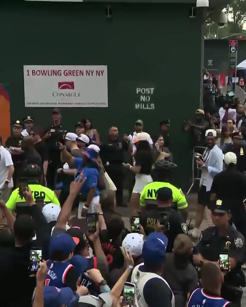 The Knicks have arrived for their championship parade. A shirtless Jeremy Sochan is carrying the Larry O'Brien trophy.