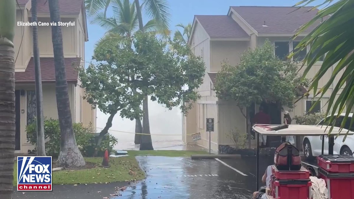 A massive wave crashes over the rooftop of an oceanfront condo in Hawaii, ripping shingles away as water surges across the building. The wave slammed into the Keauhou-Kona Surf and Racquet Condominium complex in Keauhou, sending debris flying through the air as residents watched the powerful swell roll through. It's not the first time the property has taken a hit. The same complex was battered by enormous waves in 2022 during a major swell event linked to Hurricane Darby.