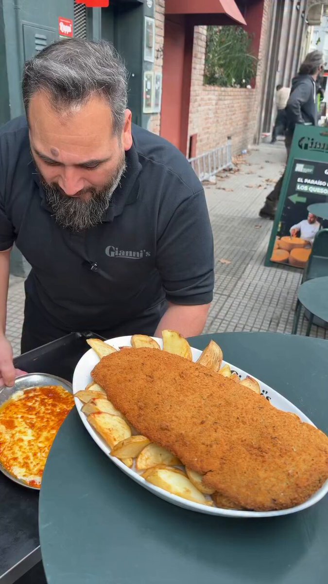 Milanesa a la Parmesana.... It consists of a breaded meat cutlet (beef) topped with tomato sauce and melted cheese. © giannispalermo
