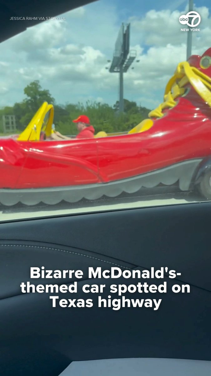 This guy is driving a Ronald McDonald shoe car on a Texas highway. Only in America