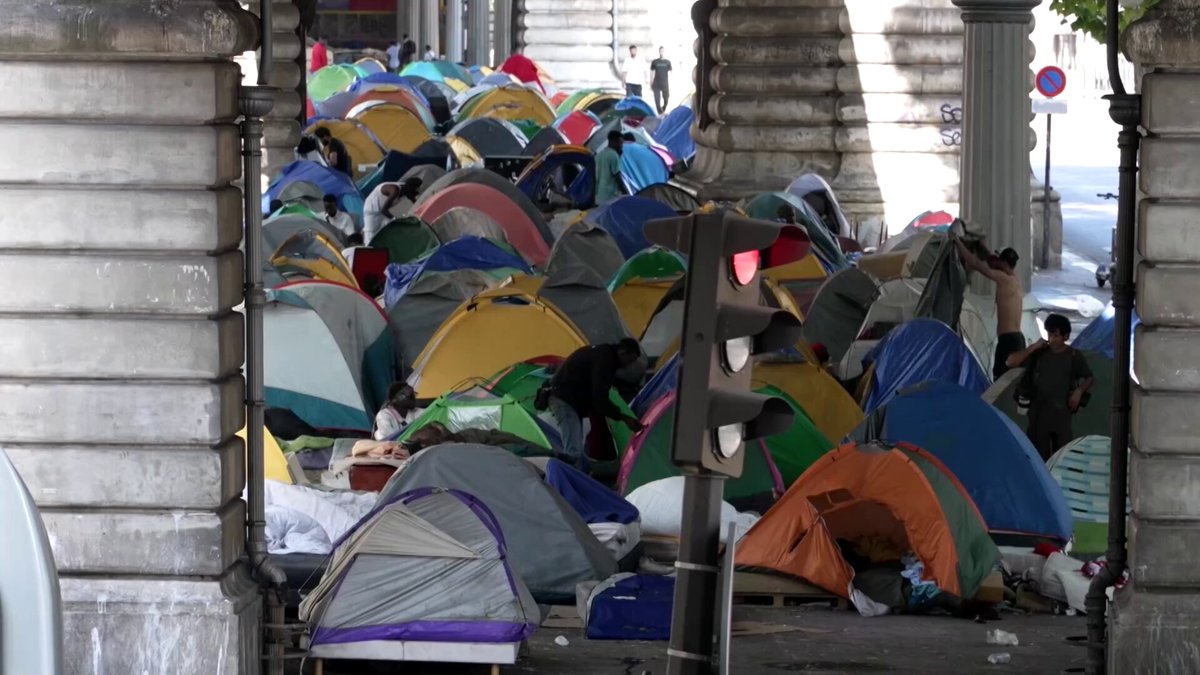 Migrants living in a Paris camp struggled to cope with scorching heat as a persisting heatwave sent temperatures skyrocketing to record highs in the city