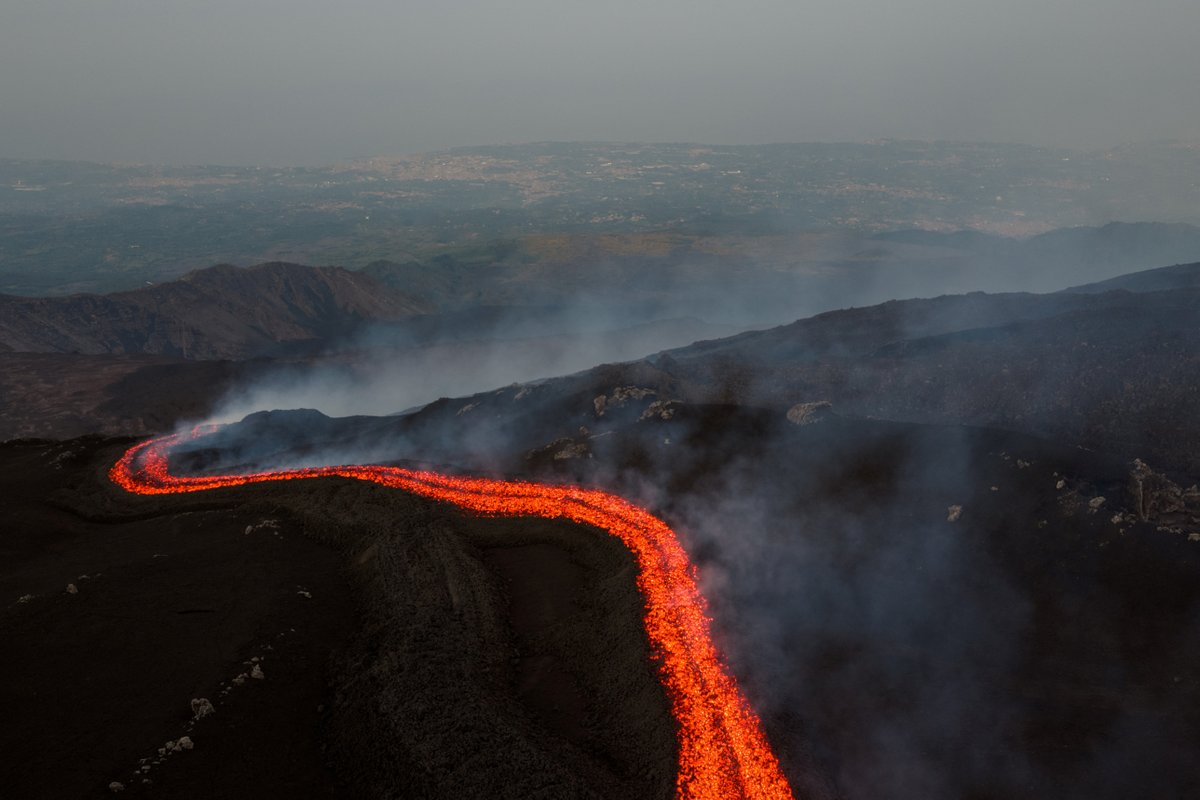 Lava from Mount Etna in Sicily lit up the sky with red flashes as eruptions continued at an altitude of 9,800 feet, Italy's National Institute of Geophysics and Volcanology reported