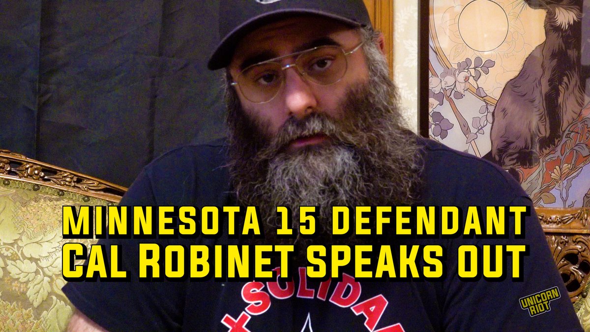 NEW: Minnesota 15 Defendant Cal Robinet Speaks Out “It’s no secret that a lot of the people that were targeted are union organizers who are being charged for some of their alleged actions on the day of no work, no school, no shopping,” said Cal Robinet, a union electrician and activist. Robinet is one of 15 people in Minnesota who were recently federally indicted on felony conspiracy charges for their community activism during ICE’s deadly Operation Metro Surge immigration enforcement. “I think it’s really important to point out that the retaliation that we’re seeing from the federal government isn’t just related to our speech, it’s related to the power that we have together.” A week after being raided by federal agents and brought to the Whipple Federal Building, Robinet spoke about their experience, opinions on the indictment, the inspiring support they’ve received from the community, Prairieland sentencing and more. Seeking to further criminalize legal observing and protesting, the federal indictment accused the defendants of opposing the authority of the government and impeding their federal operations by posting opinions to Facebook, being present at protests, attending meetings where direct actions were spoken upon, and wearing certain clothes. The indictment calls many of the defendants “anarchists” and “antifascists,” both descriptors newly named as “terror groups” in the latest White House counterterrorism strategy. These charges are a continuation of Trump’s vindictive domestic policies against the left as he directs federal agencies to go after political opponents using NSPM-7 and his executive order designating antifa as a domestic terrorist organization. “These charges are a joke,” said Robinet. “There’s nothing that we’ve done that thousands upon thousands of people haven’t done as well. These are all lawfully protected activities. And the reason that they’re throwing the book at us is because this is a political case to them. that we are enemies of state for our political beliefs, for activities as union organizers and for existing as queer people in this world.” “With regards to NSPM-7, just know that these cases are going to continue. And while we may be anarchists, please don’t think that it’s going to stop there. You know that this is just a scapegoat to try and chip off one edge of the movement, much like that Niemöller poem. You know, first they came for X and then we came for Y. Know that that’s going on today, that when they say we’re coming for anti-fascists, what they’re calling Antifa is a boogeyman that doesn’t exist. What they’re doing is they’re going after anybody who says no to them. And you should not be surprised when that starts applying to you. It’s interesting to me that they put opposition to the US government in part of the conspiracy, because to them, I could see why that would be a major crime. Because they want obedience at all costs. They love it. They just love that shit. But we’re free people. We’re free people, and we do as we please. And we love as we please, and we live as we please. You know, to live in love, we must fight. And that’s the situation that we’re put in now. We’re standing up for any immigrant, any person of color or anyone who stands in their way, that’s who they’re coming after. And that’s who we need to be protecting right now.” Read more on the case at our website.