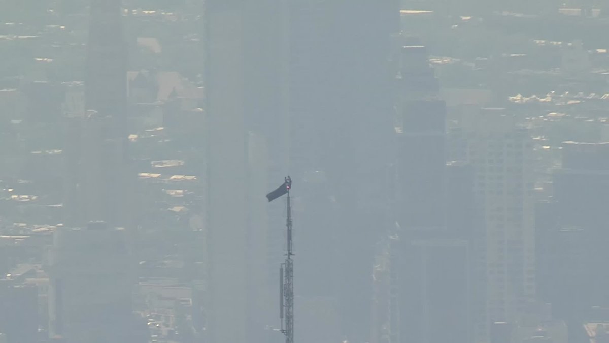 Two people wearing black have climbed to the top of the Empire State Building. More: