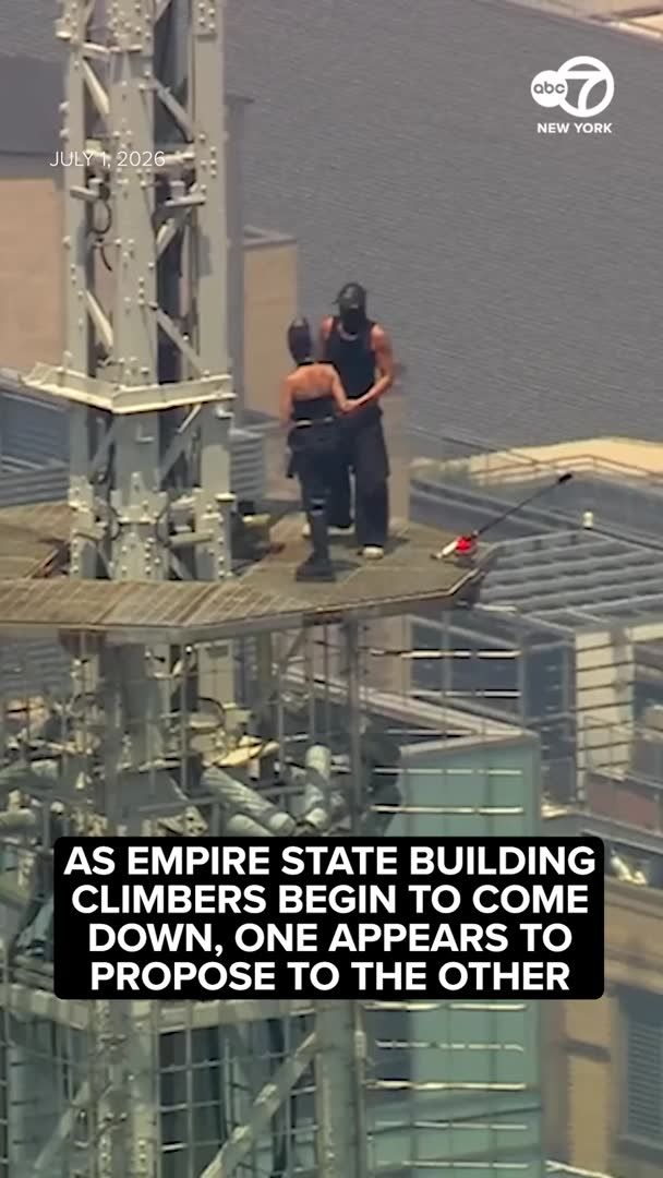 Two people wearing black climbed to the top of the Empire State Building's transmitter on Wednesday. As they were climbing down, the male climber appeared to propose to the female climber, pulling out a ring. More: