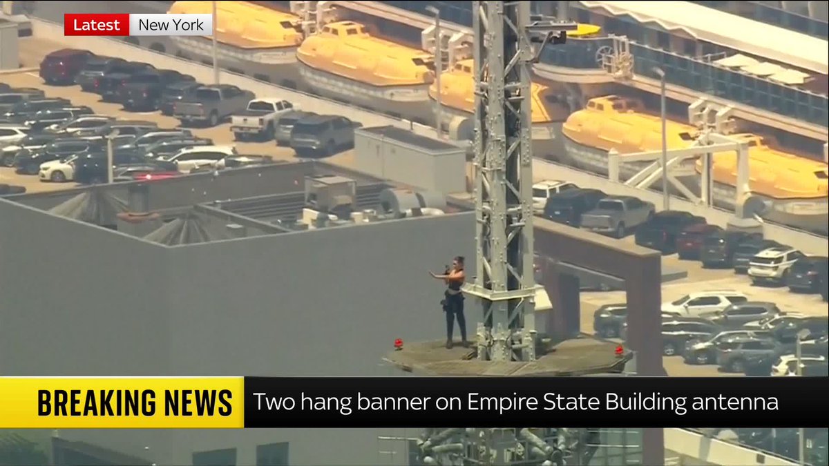 BREAKING: Two people who climbed to the very top of New York's Empire State Building to hang a banner urging world peace appear to have turned the stunt into an elaborate wedding proposal.