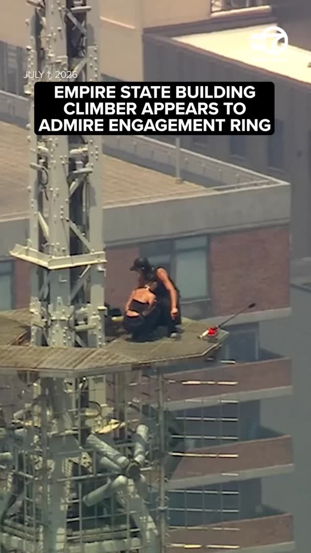 Two people in black climbed to the top of the Empire State Building's transmitter, and by the time they came back down, they seemed to be engaged. More: