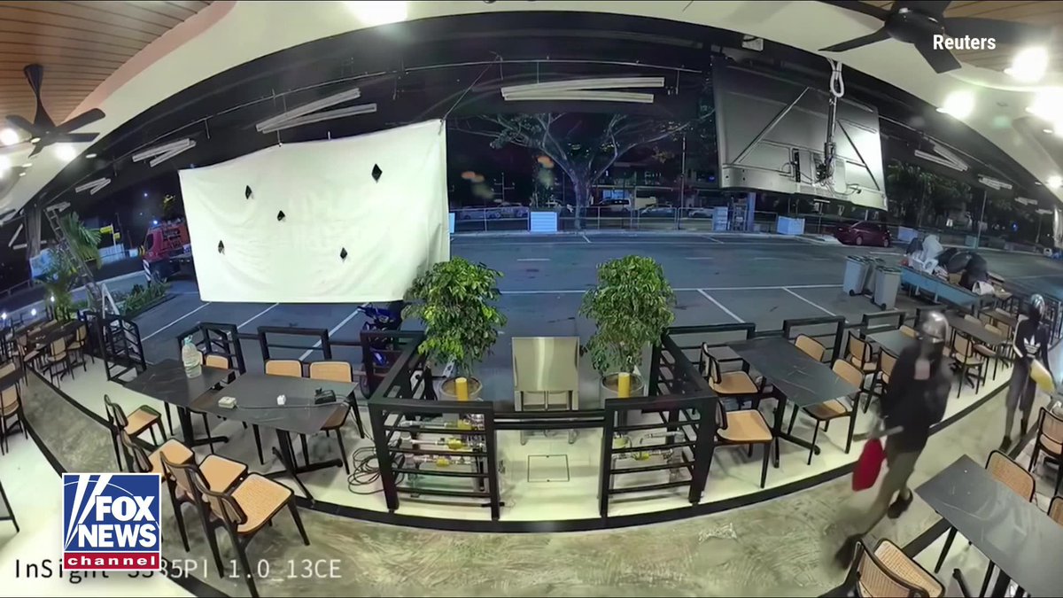 An alleged arson attempt took an unexpected turn when one of the suspects accidentally set his own feet on fire while torching a newly opened restaurant in Malaysia. Surveillance video shows two masked men pouring fuel and splashing red paint around the restaurant before setting it ablaze. As the flames erupted, one suspect's shoes caught fire, sending him running away with the soles still burning. The fire damaged the restaurant's ceiling and left red paint splashed across the entrance. Police are investigating the incident.