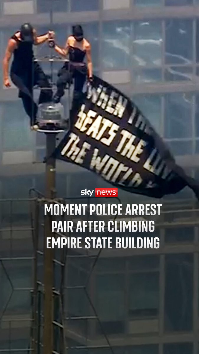 Two people have been arrested after scaling the Empire State Building’s antenna and unfurling a banner about “the power of love.”