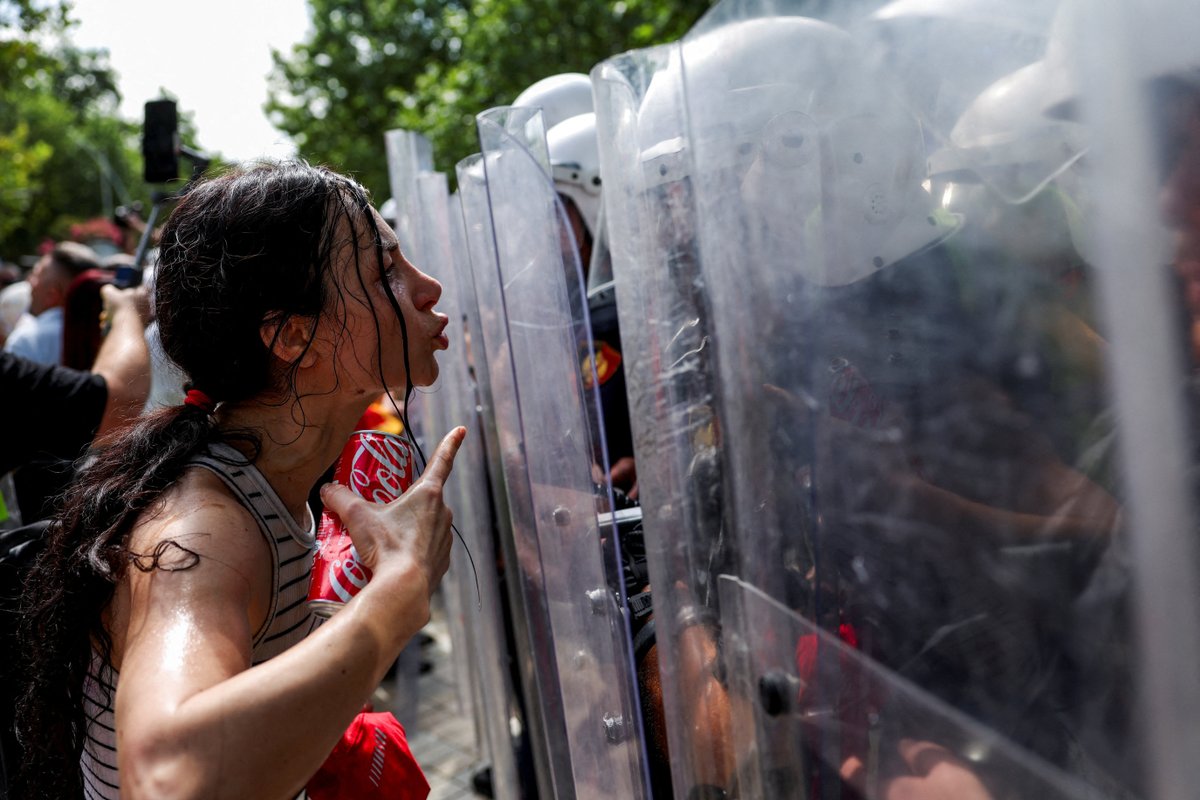 Albanian police used tear gas and water cannons to disperse anti-government protesters in Tirana, where clashes left three officers and one protester injured