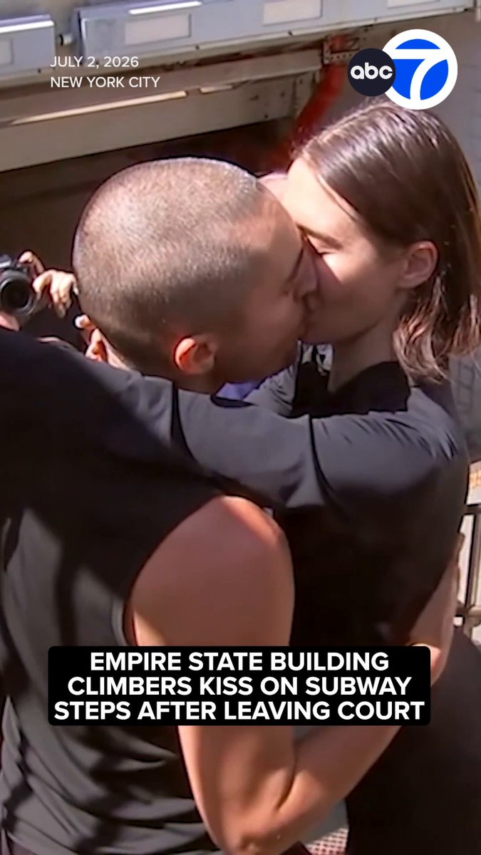 The couple that got engaged after climbing the Empire State Building spire on Wednesday shared a kiss on the subway steps after they left court on Thursday.