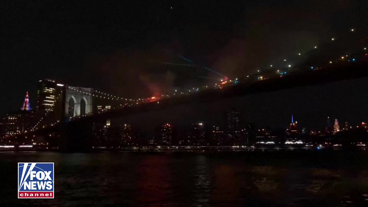 BREAKING: The Brooklyn Bridge briefly caught fire during New York City's Independence Day fireworks show. Video captured flames and thick smoke rising from multiple sections of the bridge as fireworks continued exploding overhead. The fires were extinguished within about a minute, and it's still unclear if the iconic bridge suffered any damage.