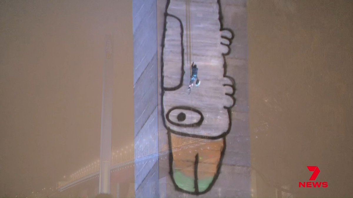 A bird-brained stunt on top of the Bolte Bridge has sparked an 8-hour standoff with police. Melbourne's 'Pam the Bird' graffiti vandal was at it again, taunting officers and ranting about everything from snacks to tax from 140 metres up. Jordan Quinn