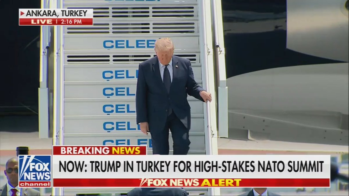 Trump gingerly walks down the steps, claps awkwardly, then has to be led down the runway by Erdogan as he struggles to walk in a straight line