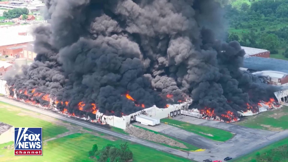 Thick black smoke swallowed the sky as a massive warehouse fire tore through Parkersburg, West Virginia. Drone video captured the enormous plume rising from the Peoples Cartage warehouse as firefighters battled the blaze for hours. Gov. Patrick Morrisey declared a State of Emergency for Wood County, with state agencies mobilized to support the response and monitor any potential environmental impacts. The cause of the fire remains under investigation.
