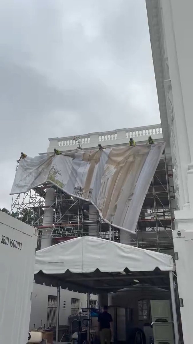 The White House has put up a printed tarp to obscure new scaffolding on the facade of the building.