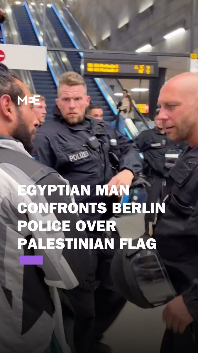 An Egyptian man stood in the face of a Berlin police officer and prevented him from grabbing a Palestinian flag in a public transit station, as onlookers cheered on the protestor in his act of defiance
