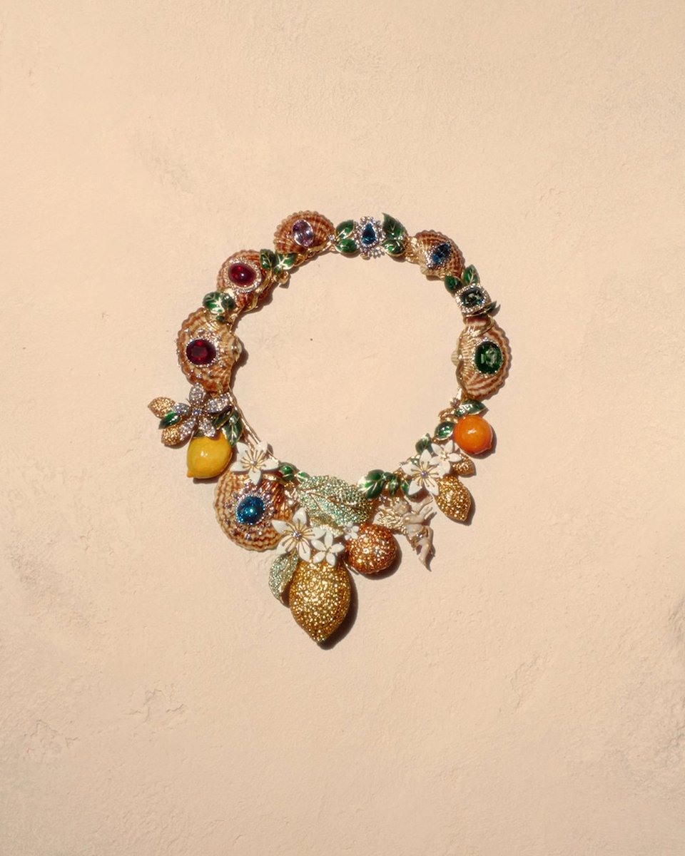 Part of the new #DolceGabbana Taormina Collection, this #DGAltaGioielleria necklace transforms Sicily’s landscape into an extraordinary display of craftsmanship. Created in gold and titanium, it combines lemons, oranges, shells, orange blossoms, and botanical motifs shaped through complex goldsmithing techniques, intricate enamelling and pavé-set sapphires, tsavorites and diamonds. The result of meticulous #DGFattoAMano handcraftsmanship and extensive artistic research, it is on display at San Domenico Palace. #MadeInItaly
