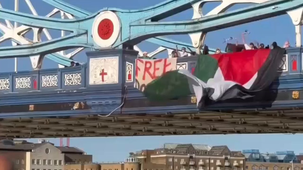 People wave Palestinian flags &amp; a ‘Free Dr Hussam’ banner on London Bridge, demanding his release &amp; an end to the israeli genocide in Gaza