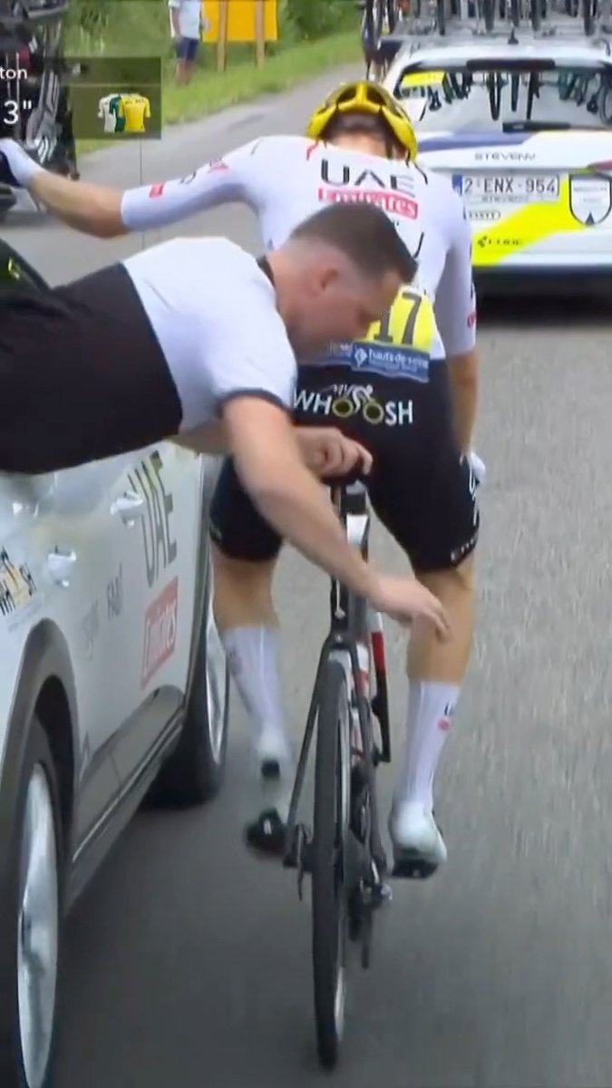 Even the team staff risk it all at the Tour de France 😳 Throwback to this UAE Team Emirates mechanic hanging out of the car to fix the gears!