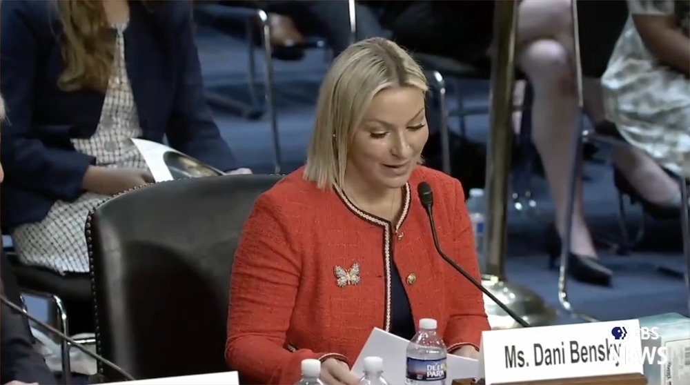 Dani Bensky, Epstein survivor: I'd like to remind you of who you're hearing from today. At this time, can my survivor sisters and family please rise? We were children at the time of our abuse. Look at our faces and remember the women and families of those who the DOJ re-victimized.