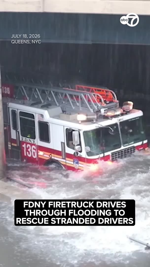 INSANE FLOODING: A Queens firetruck drove through floodwaters deep enough to float an SUV as firefighters rescued stranded drivers from the roof of a truck.