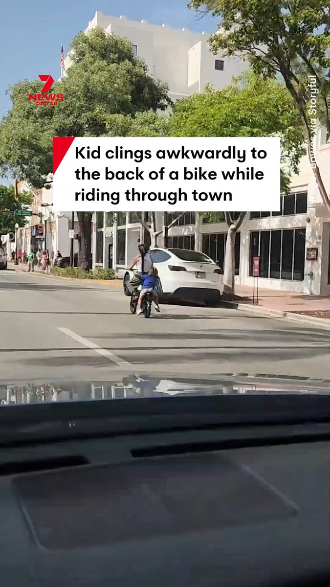 Video footage has captured the moment child hanging onto the back of the bike during a ride through town in Miami, Florida. The child was seen clinging onto the woman's waist, dangling off the bike. #miami #florida #bikesafety