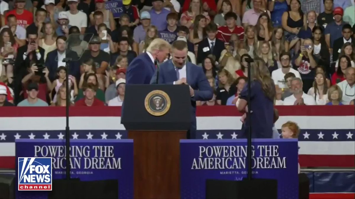 WATCH: President Trump holds the hand of a child whose family enrolled in Trump Accounts.