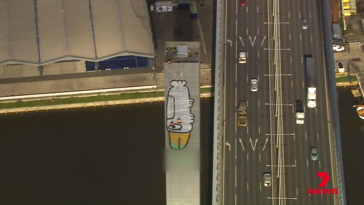 Highly trained abseiling painters lead the mission to remove 'Pam the bird' graffiti from the Bolte Bridge. A team of up to 12 is painting over Pam but Mother Nature might have other ideas. @Blakejohnson