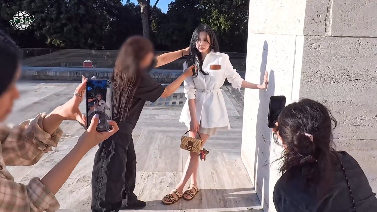 Mina taking photos in Rome with the wind as a paid actor