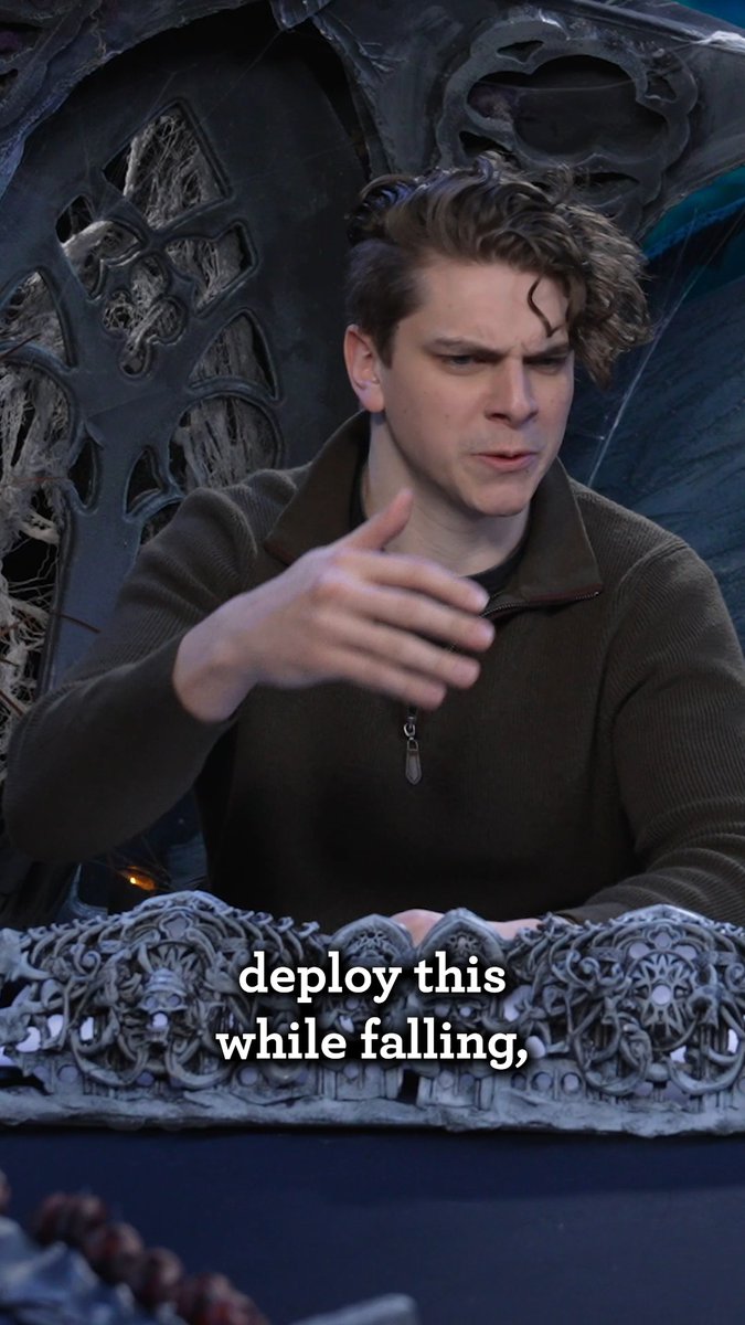 IT'S KIND OF A ONE-TIME THING 💀 🪂 Alphonse Brute (Zachery Renauldo) explains how our survivors' newly unfolded glider works as they run into a snag in #AgeOfUmbra: Sallowlands, Episode 2 - "The Onyx Spire", available now on YouTube and #daggerheart #actualplay #survivalhorror #ttrpg