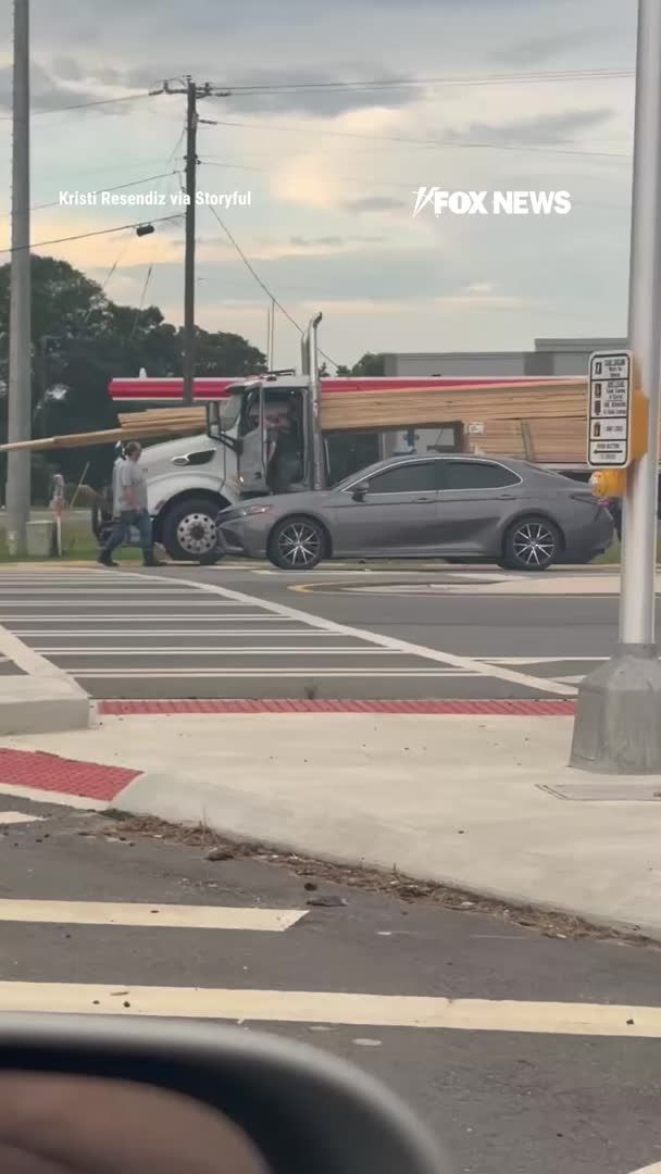 A semi-truck driver miraculously walked away from this crash with only minor injuries. Shocking video shows a load of massive wooden planks that crashed through the cab during a hard stop in Georgia — piercing a massive portion of the driver's side of the windshield, leaving behind a scene that looks almost impossible to survive. Authorities say the load shifted forward when the driver slammed on the brakes. Officials say the driver was remarkably only hurt slightly.
