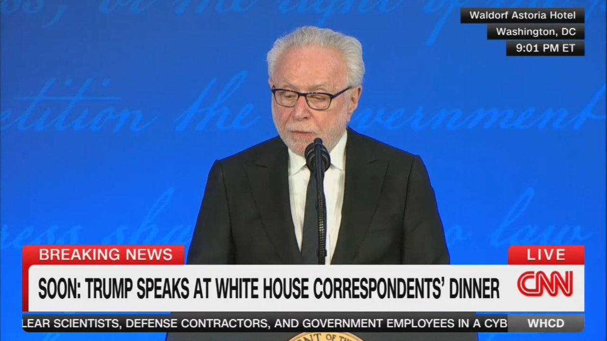 Wolf Blitzer presents an award to the photojournalist who photographed Trump standing carelessly as an Oval Office guest suffered a medical emergency next to him