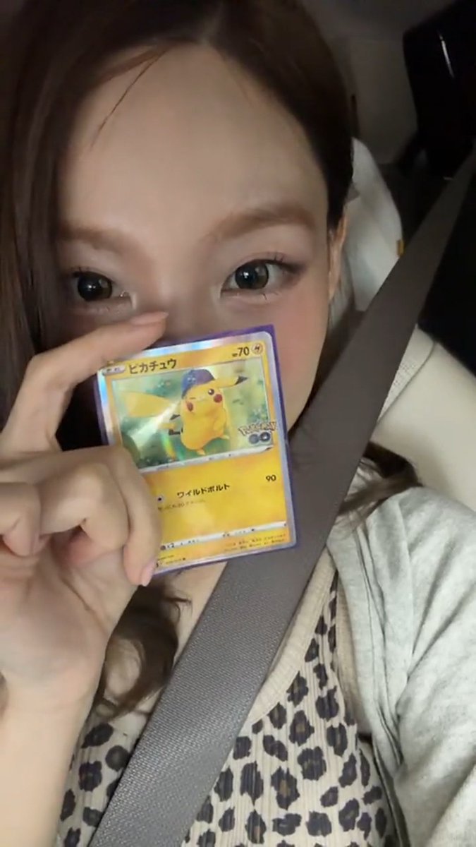 Nayeon showing off her new Pokemon cards 😭