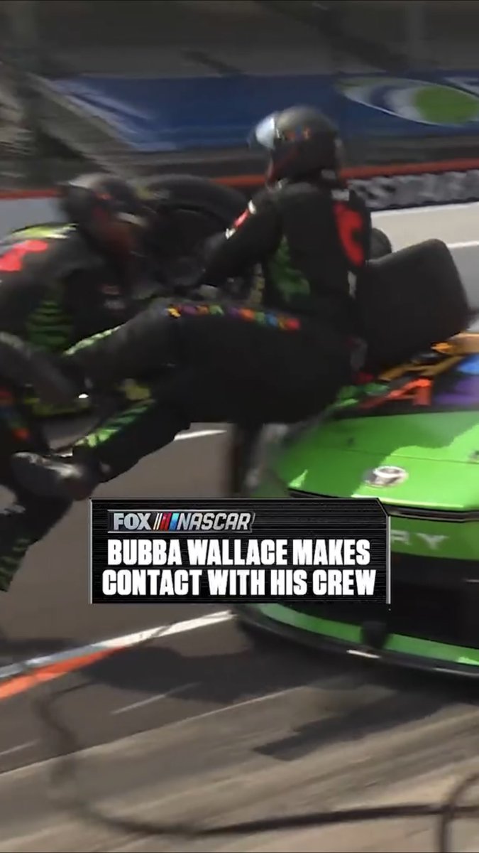 Bubba Wallace makes contact with his pit crew at Indy.