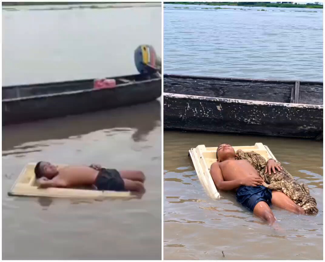 Menino é flagrado deitado em uma tampa de geladeira ao lado de um jacaré em um rio, e o vídeo viraliza nas redes sociais