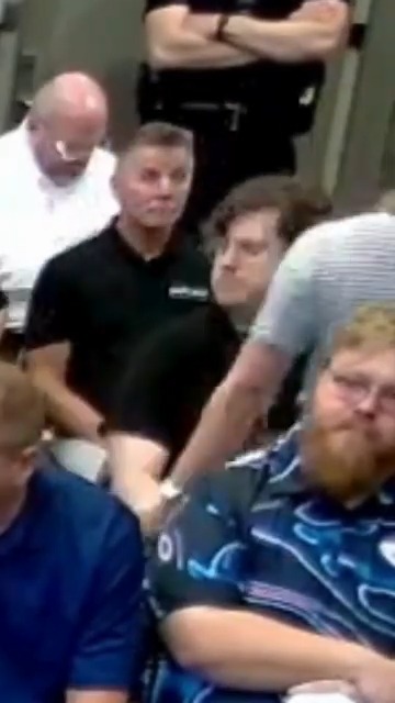A high school teacher in Kansas was arrested for clapping in opposition to a proposed data center during a city council meeting.