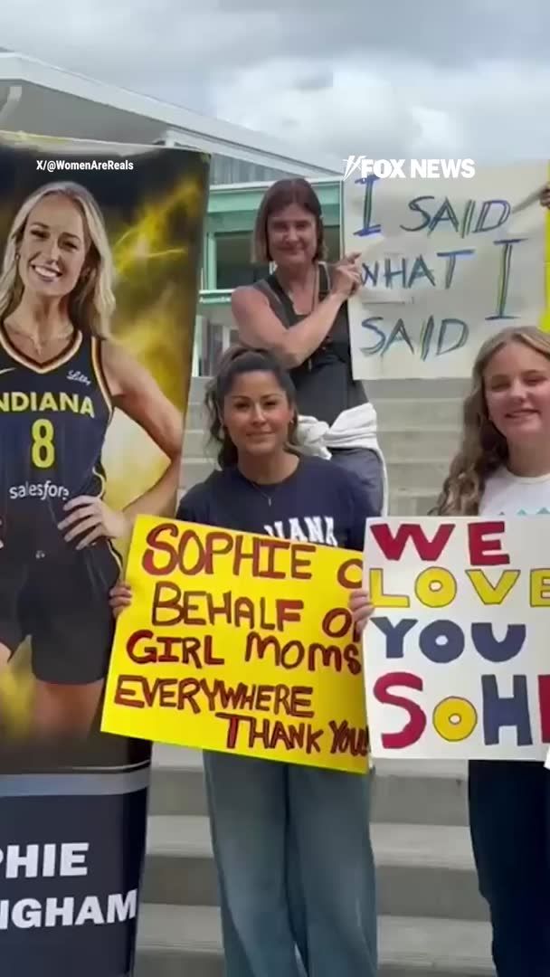 Sophie Cunningham supporters line the streets outside Seattle's Climate Pledge Arena holding "Save Women's Sports" signs and chanting in support of the Indiana Fever star after her comments on transgender athletes competing in women's sports. Counter-protesters gather nearby, creating a tense scene before tipoff as both sides face off outside the arena. During the game, Cunningham was loudly booed by portions of the crowd nearly every time she touched the ball.
