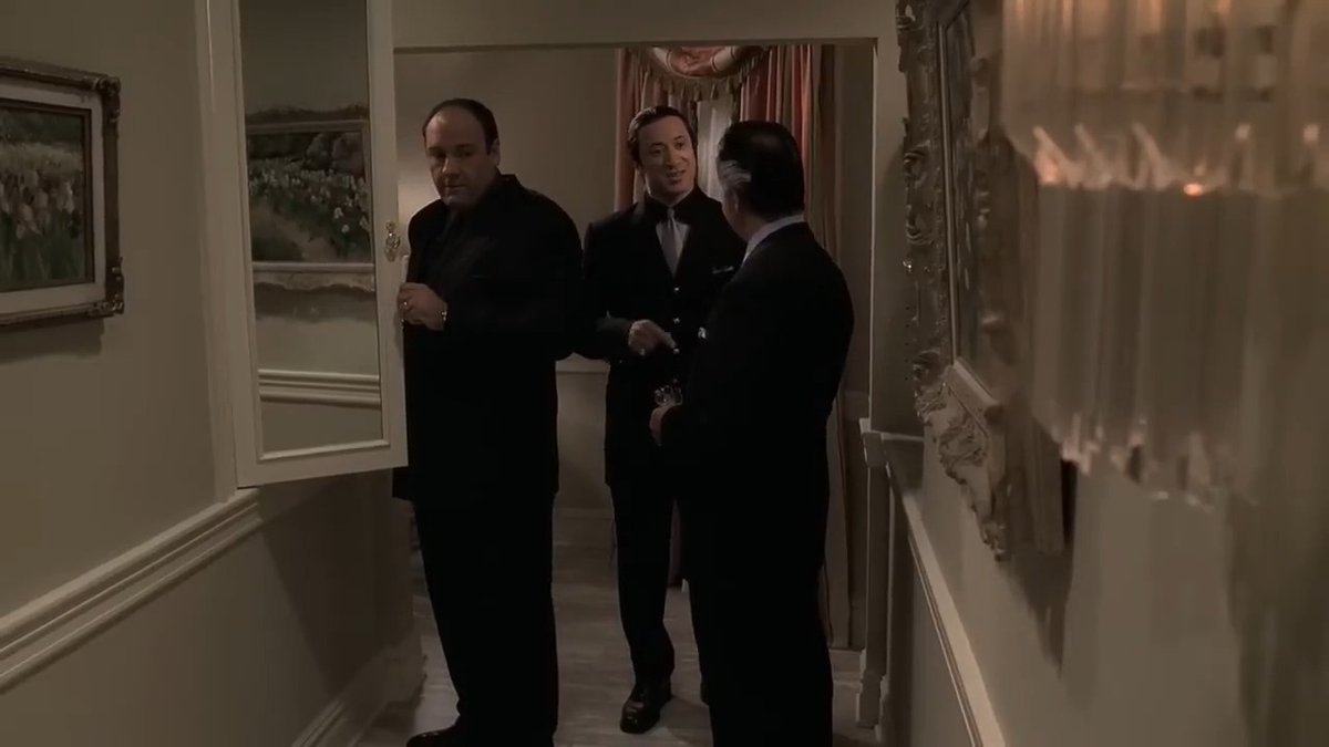 I subscribe to the idea that Tony didn't actually see Big Pussy, he just sensed him or at the very least could tell that something was...off. We the audience see Big Pussy, because the Sopranos is a television show, and the best way to convey this scene to the audience is to show Big Pussy in the mirror. If you had Tony just looking and acting uneasy while Paulie and Furio talked about something unrelated, then the scene would seem pointless and overly cryptic