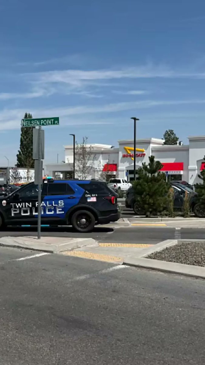 Video taken by a driver near an In-N-Out Burger restaurant in southern Idaho where three people were killed shows a bystander firing a gun at the attacker. This replaces an earlier caption that incorrectly described the actions in the video.