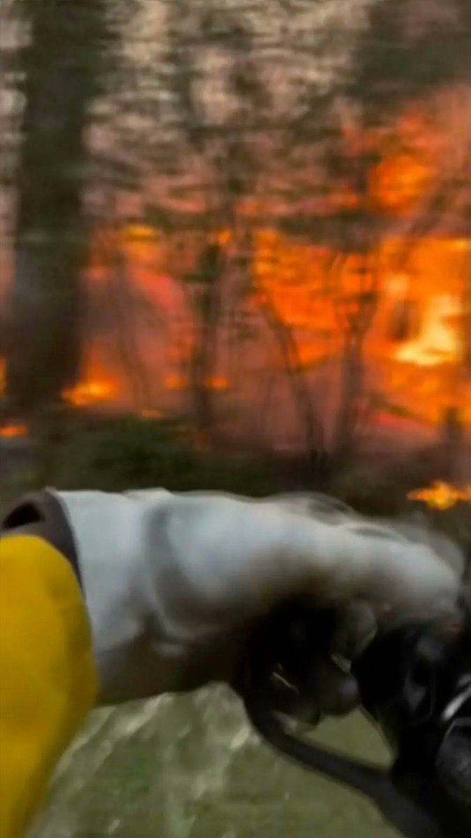 Fires have forced some 67,000 people to evacuate and destroyed at least 700 buildings. A man has been charged with setting one of the blazes.