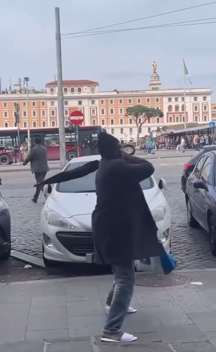 Rome 🇮🇹: Aggressive African immigrant intimidates people with an umbrella. Then he gets hit by a flying chair.