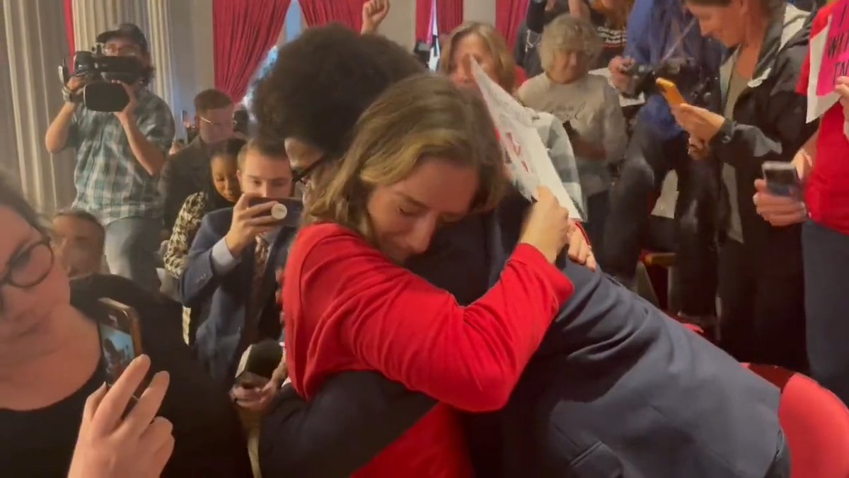 In 2023, TN-09 Democratic nominee Justin Pearson comforted a woman holding a sign reading "Covenant Mom" after the Covenant School shooting in Nashville