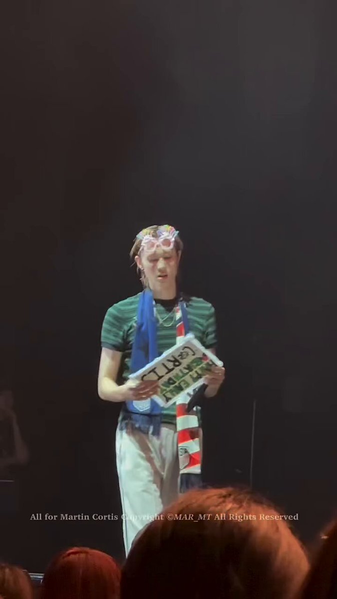 another angle of martin holding the “happy early birthday cortis” sign. he looks so emotional 😭🥺