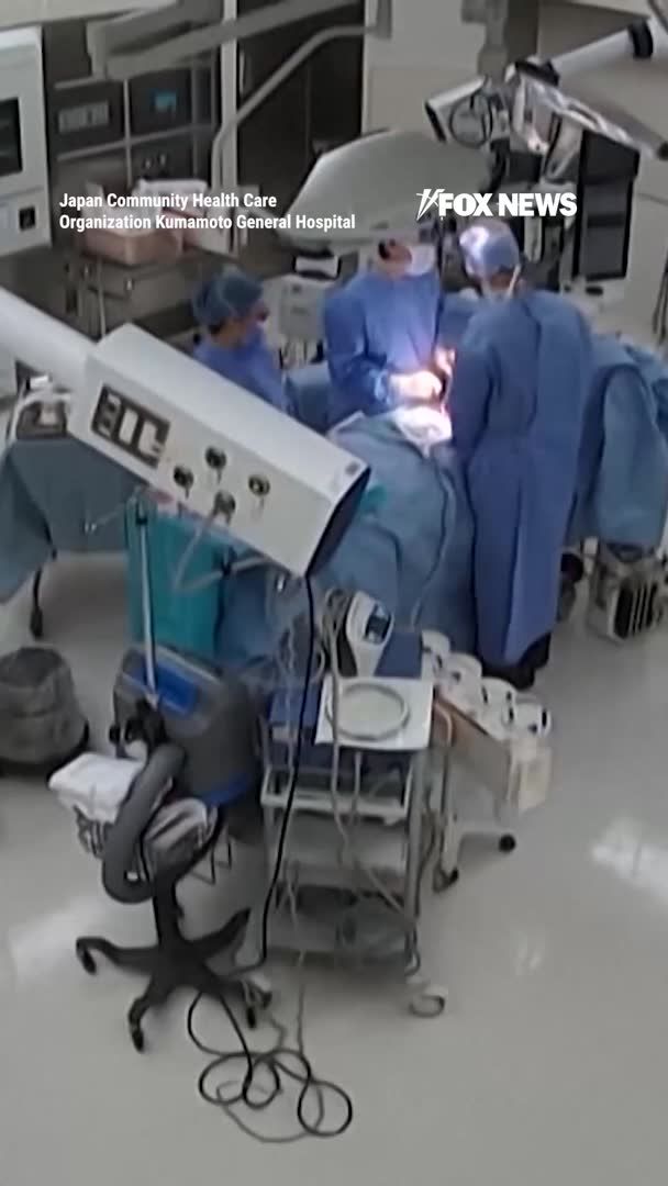 Surgeons cling to a patient on the operating table mid-surgery as a powerful 7.1 magnitude earthquake violently shakes a Japanese hospital. Surveillance video shows equipment rattling and staff scrambling to keep items from falling while the surgical team works to protect the patient as the room moves around them. The earthquake struck southwestern Japan, killing at least 39 people and forcing thousands into evacuation centers.